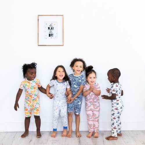 Children smiling under youth wall decor